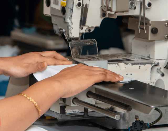 Sewing machine being used by an employee in Bangladesh.