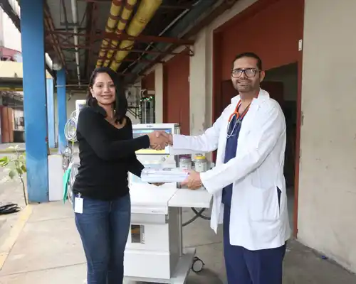 Gildan employees and holding a basketball trophy while wearing their blue and white jerseys.