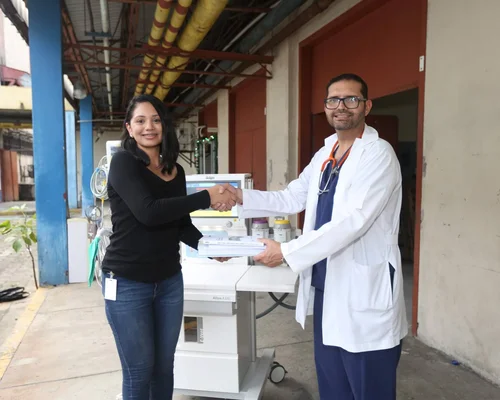 Gildan employees and holding a basketball trophy while wearing their blue and white jerseys.