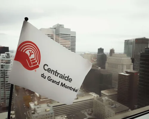 Employees are smiling and raising their hands in the air at the front desk.