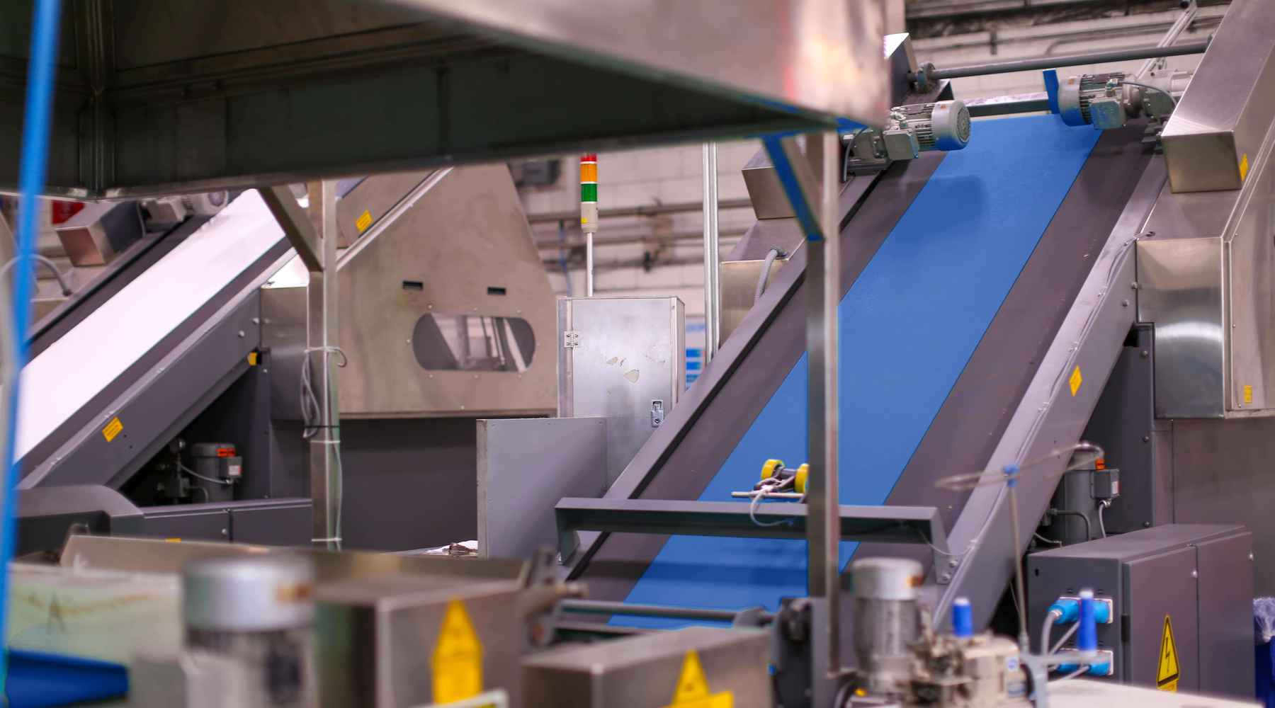 Blue fabric is rolling through a drying chambers at the textile facility.