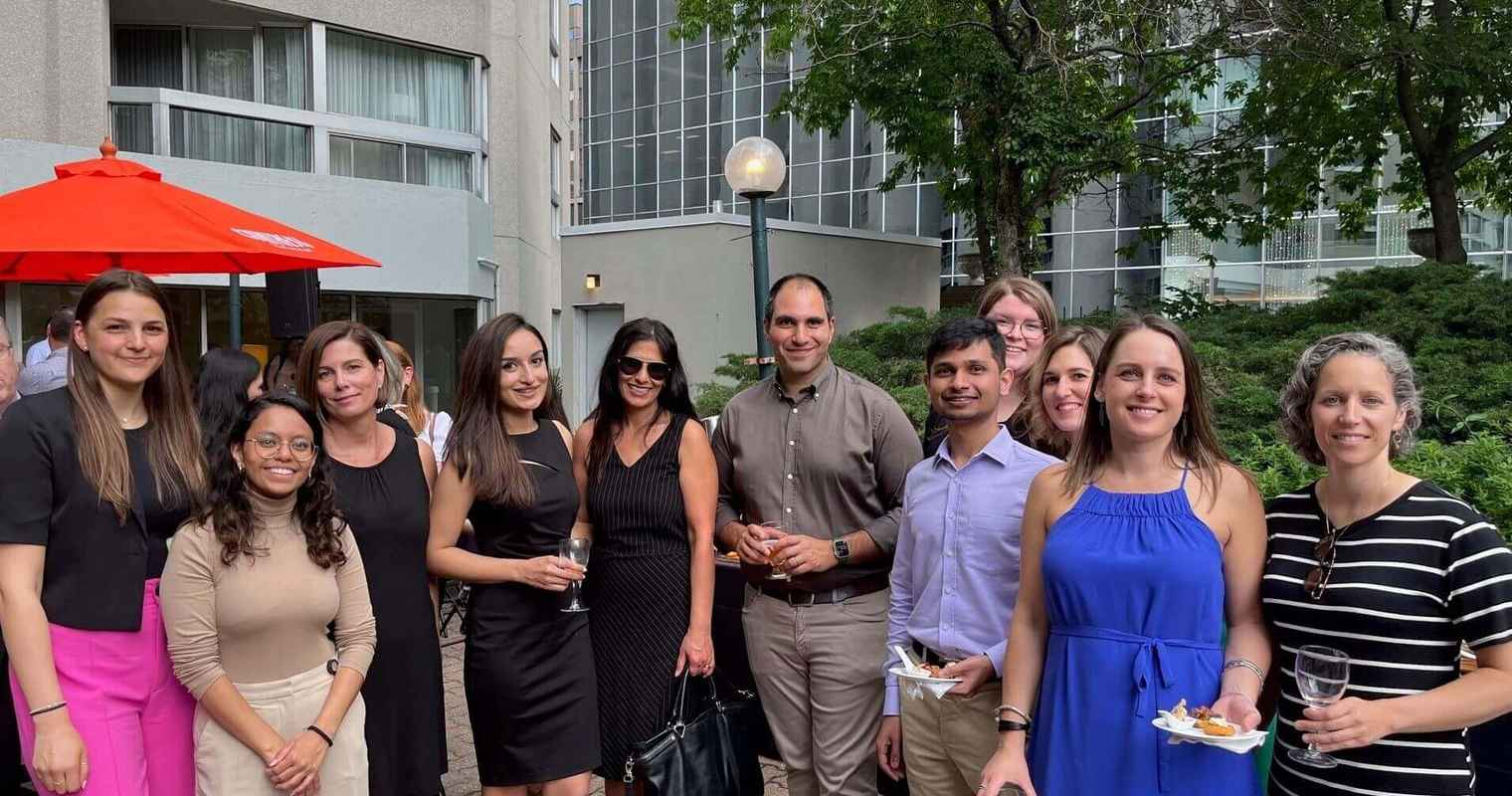 A group of Gildan employees from the Corporate Head Office in Montreal are smiling while outside.